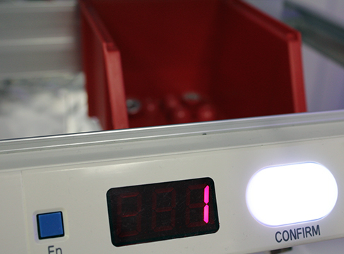 Small parts bin picking application with pick-to-light for lean manufacturing.
